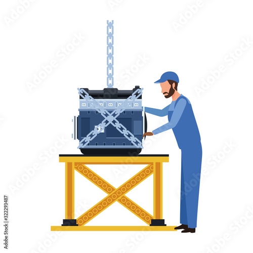 mechanic standing supervising a car engine on a table