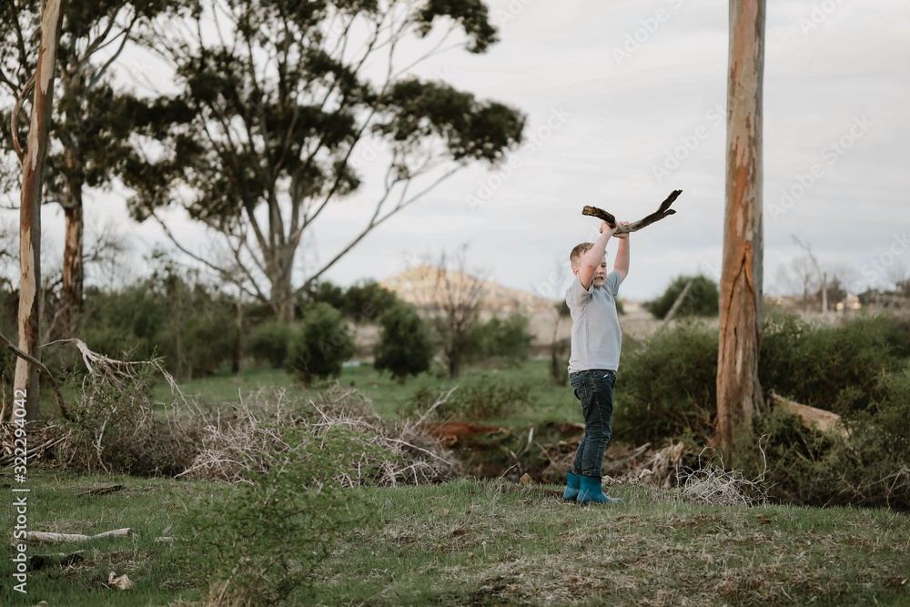 Young boy exploring run down farm Young boy exploring run down farm