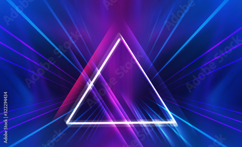 Dark abstract futuristic background. The geometric shape of a triangle in the middle of the scene. Neon blue-pink rays of light on a dark background