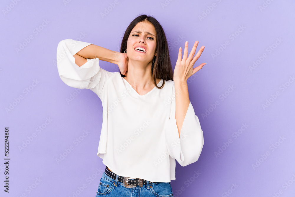Young caucasian woman isolated on purple background screaming with rage. Young caucasian woman isolated on purple background screaming with rage.
