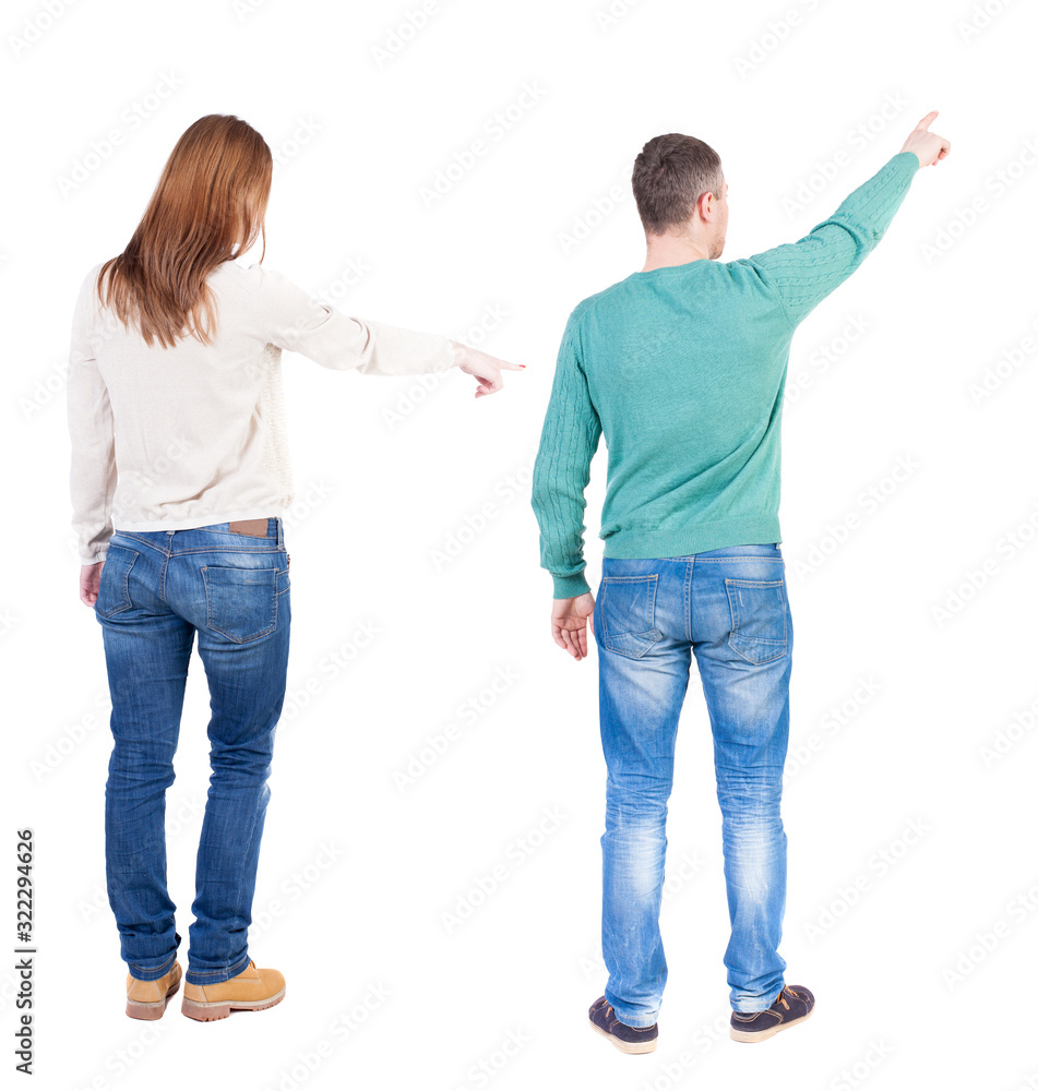 Back view of couple couple in sweater pointing. Back view of couple couple in sweater pointing.