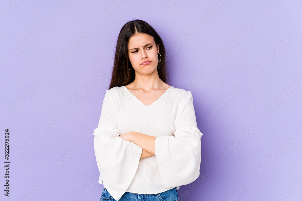 Young caucasian woman isolated on purple background tired of a repetitive task. Young caucasian woman isolated on purple background tired of a repetitive task.