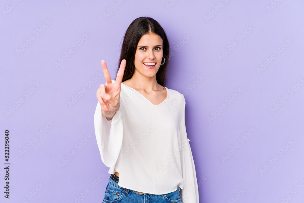 Young caucasian woman isolated on purple background showing number two with fingers. Young caucasian woman isolated on purple background showing number two with fingers.