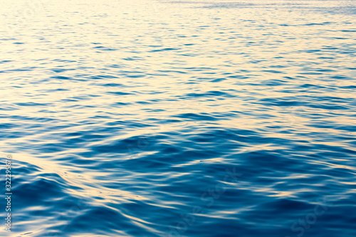 Surface of a calm blue sea. Selective focus. Shallow depth of field. Toned