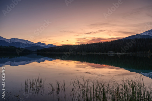 Patricia lake with mountain range and pine forest reflection at evening