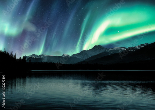 Aurora Borealis  Northern Lights over Canadian Rockies in forest on Pyramid lake at Jasper national park