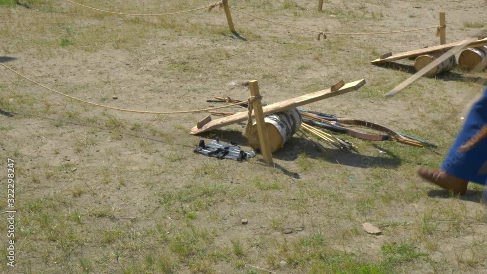 Bows for shooting lie on the ground, archer girls are in old clothes. Bows for shooting lie on the ground, archer girls are in old clothes.