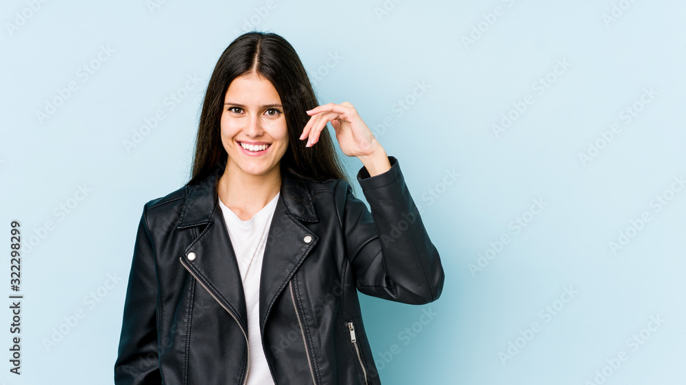 Young caucasian woman isolated on blue background laughing about something, covering mouth with hands. Young caucasian woman isolated on blue background laughing about something, covering mouth with hands.