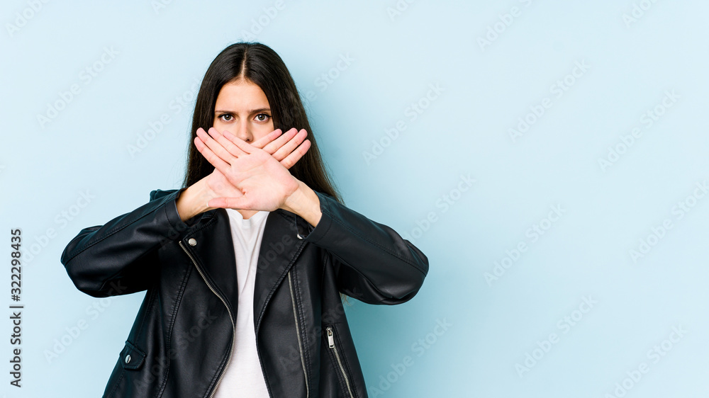 Young caucasian woman isolated on blue background doing a denial gesture Young caucasian woman isolated on blue background doing a denial gesture