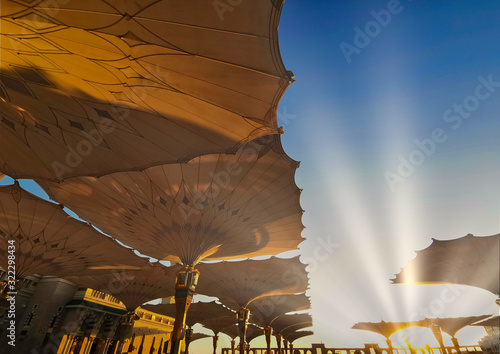 Medina, Saudi Arabia - August 25, 2019: Sunrise or golden hour view during haze weather at Nabawi Mosque or Prophet Mosque in Medina, Saudi Arabia.