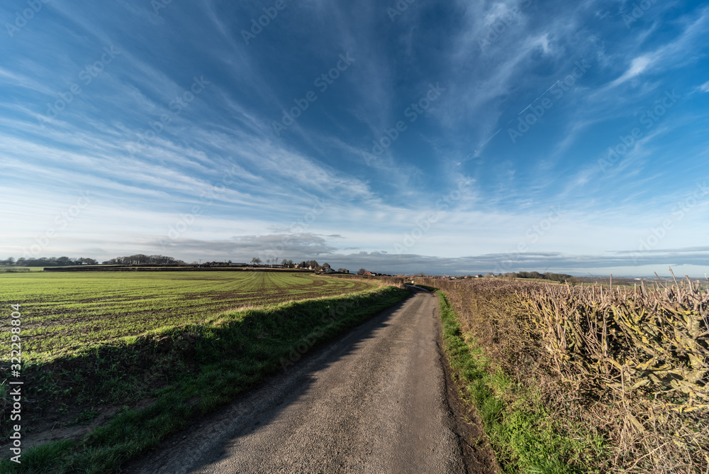 Clouds over the road on a sunny day