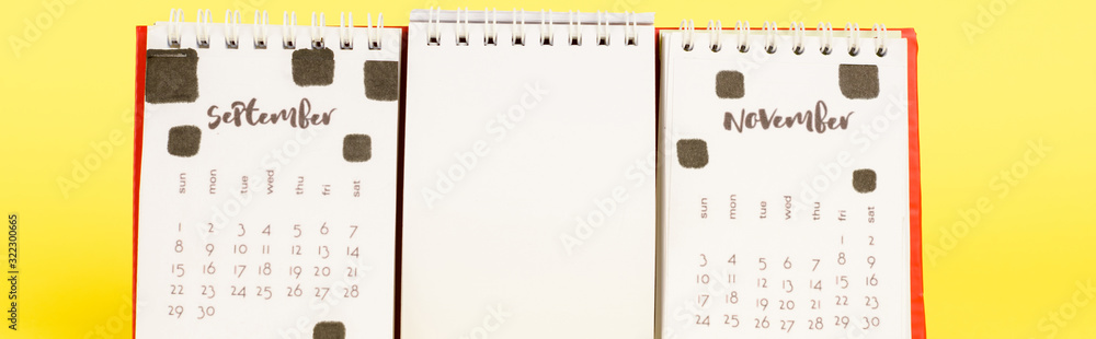 Panoramic shot of calendar with autumn months and empty blank on yellow background Panoramic shot of calendar with autumn months and empty blank on yellow background