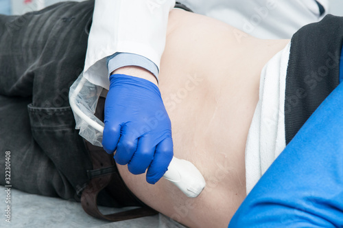 Ultrasound scan of a man   s abdomen in a hospital