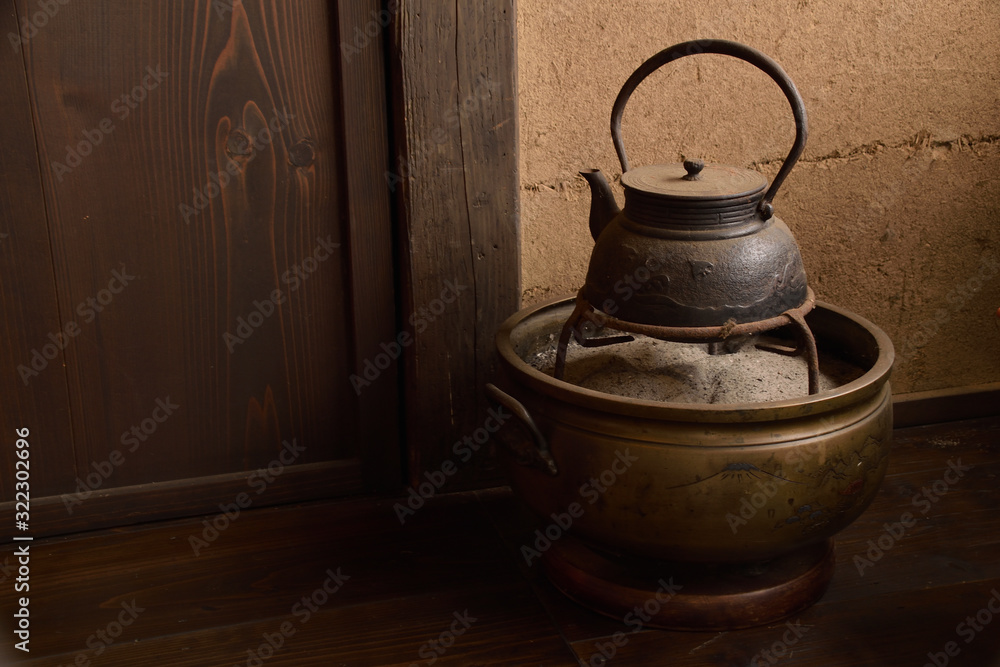 Japanese fire bowl and Iron kettle. Traditional Japanese heating and cooking device, It is called “Teaburi” or “Hibachi” . Traditional Japanese iron kettle, it is called “Tetsubin”. Japanese fire bowl and Iron kettle. Traditional Japanese heating and cooking device, It is called “Teaburi” or “Hibachi” . Traditional Japanese iron kettle, it is called “Tetsubin”.