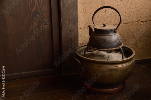 Japanese fire bowl and Iron kettle. Traditional Japanese heating and cooking device, It is called “Teaburi” or “Hibachi” . Traditional Japanese iron kettle, it is called “Tetsubin”.