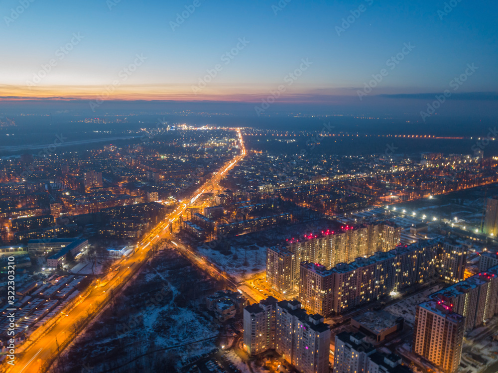 Aerial drone view. Evening illumination of the snowy city of Kiev.