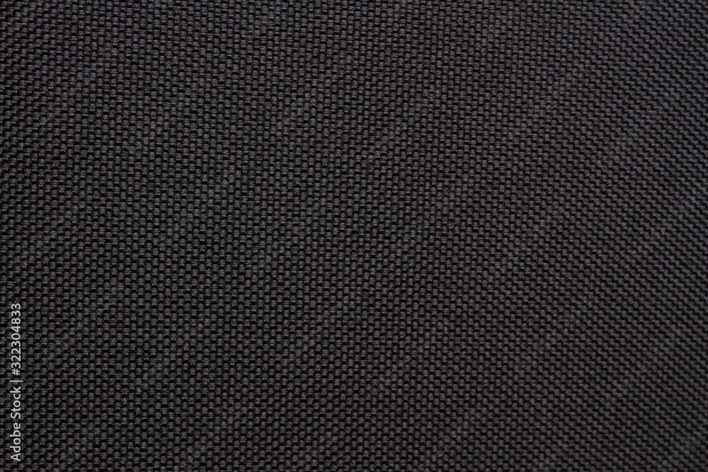 Black dense fabric, background. Close-up. Black dense fabric, background. Close-up.