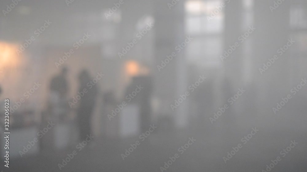 Many people walk in a smoke filled room Many people walk in a smoke filled room