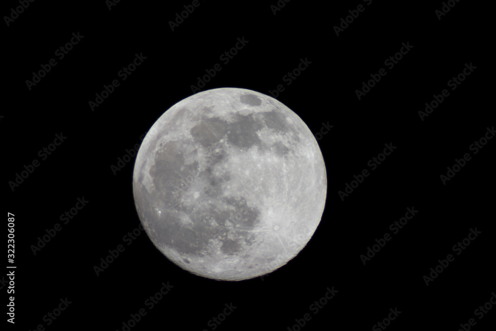 Full moon through a telescope on a dark night Full moon through a telescope on a dark night