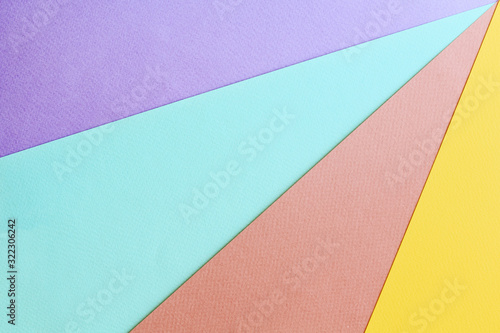 Soft geometric pastel background with multicolored diagonal rays made from watercolor paper.