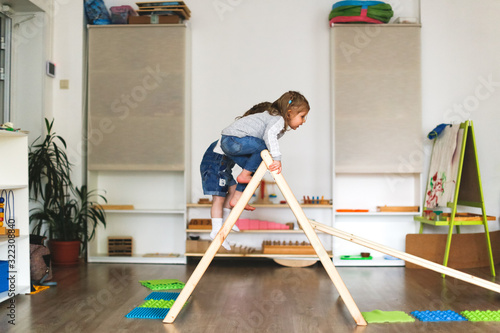 toddlers on wooden staircase Montessori center