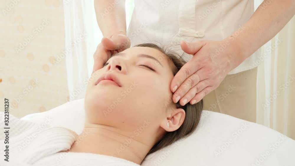 Young Asian woman getting spa massage treatment at beauty spa salon. Face massage, Relaxing massage, Spa skin and body care. Young Asian woman getting spa massage treatment at beauty spa salon. Face massage, Relaxing massage, Spa skin and body care.