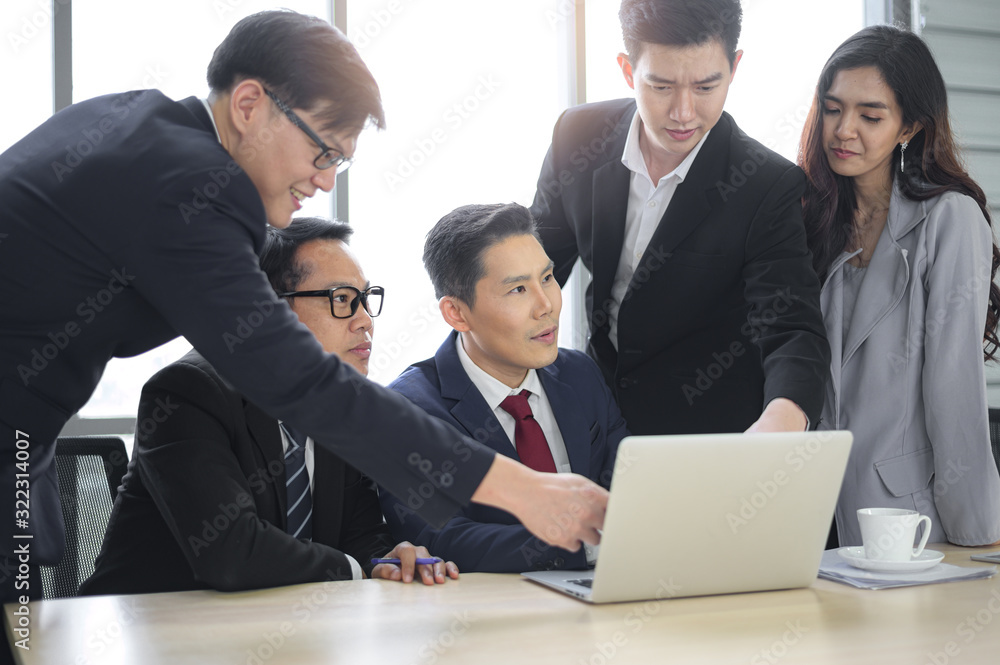 Asian businessmen talk in a meeting room during an office meeting. Asian businessmen talk in a meeting room during an office meeting.