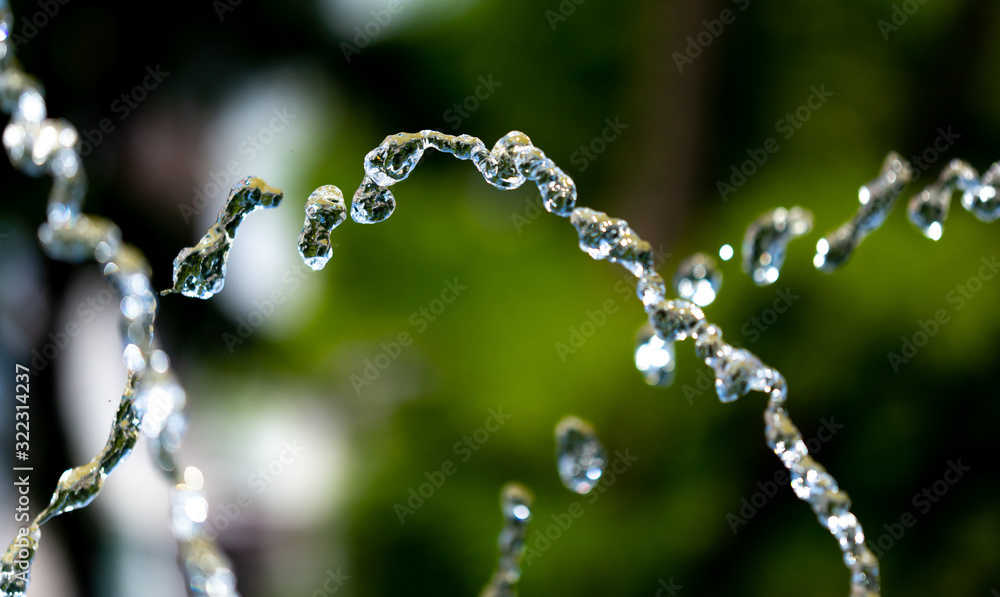 Water splashing from a fountain on summer nature Water splashing from a fountain on summer nature