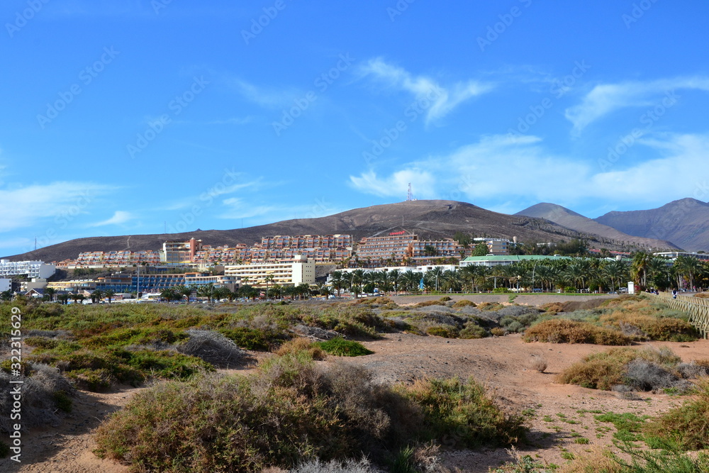 Hotels in Morro Jable seen from the Matorral beach/ or Jandia Playa. Beautiful dunes and hotel resort view. Morro Jable, Fuerteventura, Canary Islands, Spain