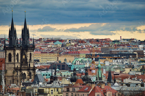 Beautiful view from the park at Prague streets, old historical buildings and rooftops © Jakub