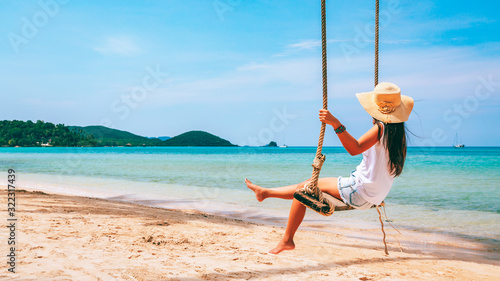 Woman on swing in beach photo