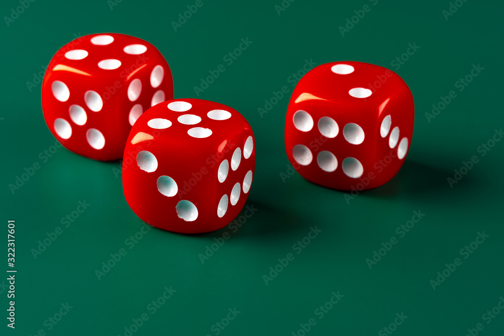 Red dice on green background close up Red dice on green background close up