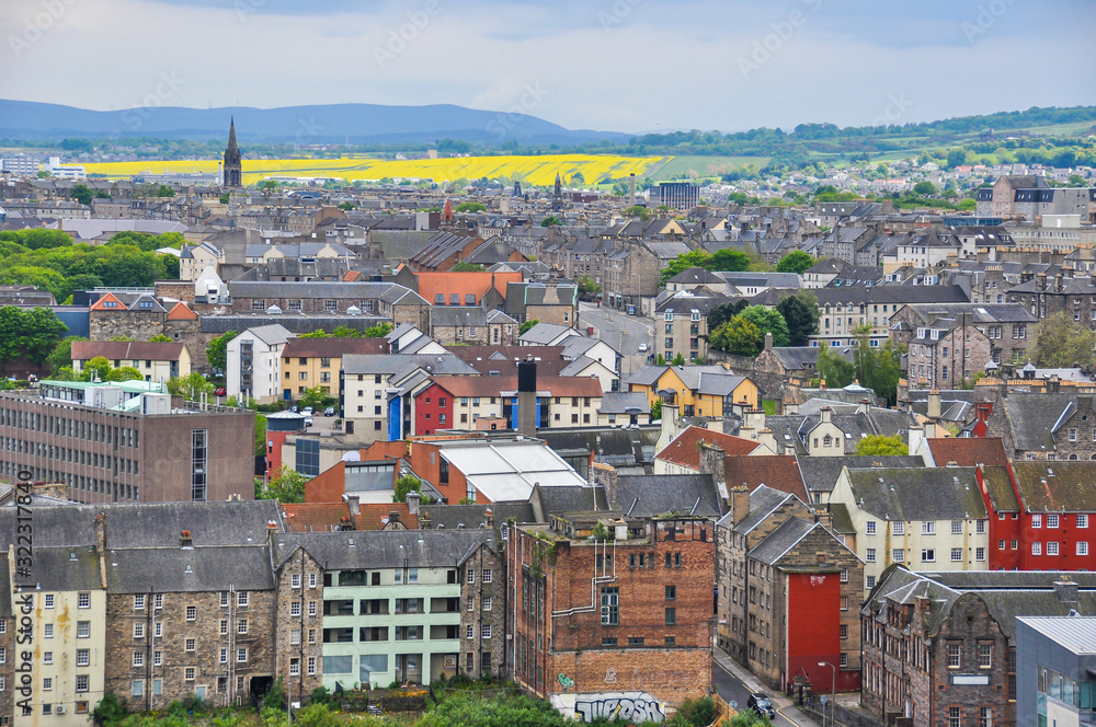 Beautiful landscape picture taken from Calton Hill looking down on Edinburgh City with its colourful houses and yellow fields