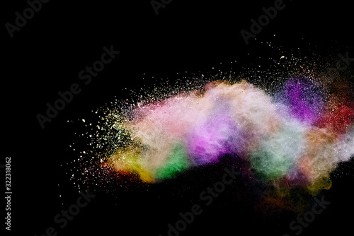 Abstract powder splatted background. Colorful powder explosion on black background. Colored cloud. Colorful dust explode. Paint Holi.