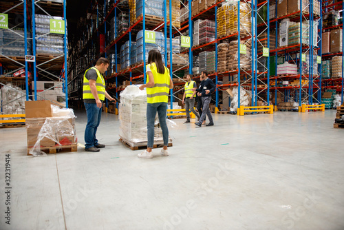Managers in Warehouse discuss about business © Stock Rocket