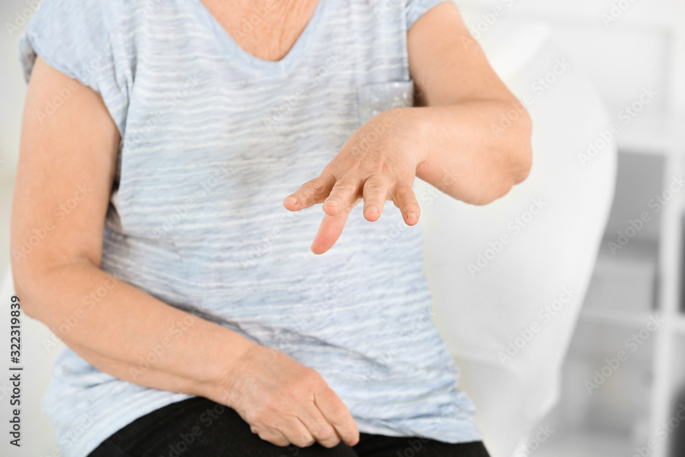 Senior woman suffering from Parkinson syndrome in clinic Senior woman suffering from Parkinson syndrome in clinic