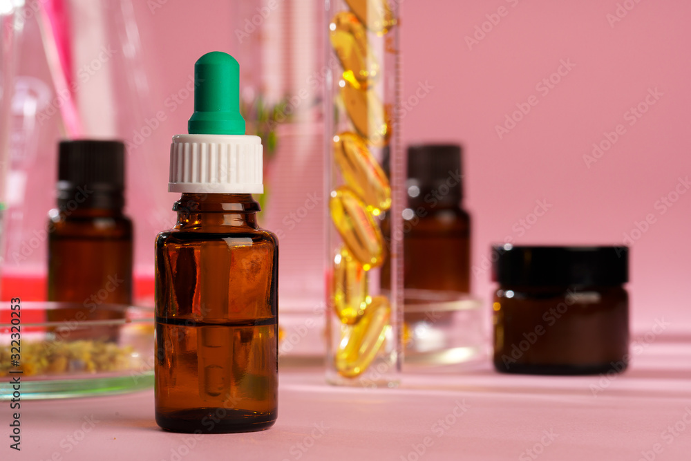 Health, skin care and beauty concept. Cosmetic containers on pink background with plant leaves Health, skin care and beauty concept. Cosmetic containers on pink background with plant leaves