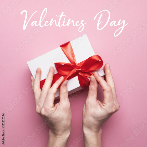Unrecognizable Female Hands Packed Gift For Valentines Day On Pink Background With Text