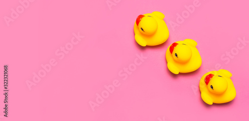 Trend Inflatable Children toy for swimming. Inflatable Three yellow chicken or duckling on pink background, pool float party. Flat lay copy space. Creative summer beach concept. Layout for design