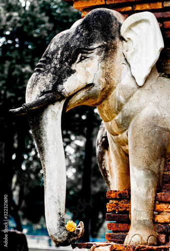 Wat Sorasak chedi surrounded by elephants. CHEDI WAT CHANG LOM (Elephant Temple).Sukhothai Historical Park covers the ruins of Sukhothai. Stupa decorated with elephant reliefs in the temple ruins photo