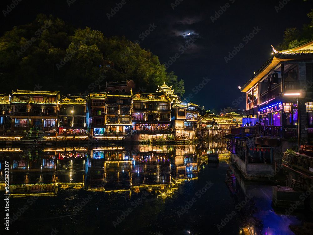 fenghuang,Hunan/China-16 October 2018:Tourist walking in the evening of fenghuang old town.phoenix ancient town or Fenghuang County is a county of Hunan Province, China fenghuang,Hunan/China-16 October 2018:Tourist walking in the evening of fenghuang old town.phoenix ancient town or Fenghuang County is a county of Hunan Province, China