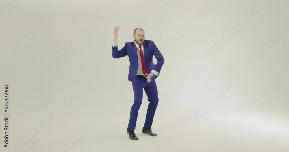 Smartly Dressed Businessman dancing on a white background - Wide Shot Smartly Dressed Businessman dancing on a white background - Wide Shot