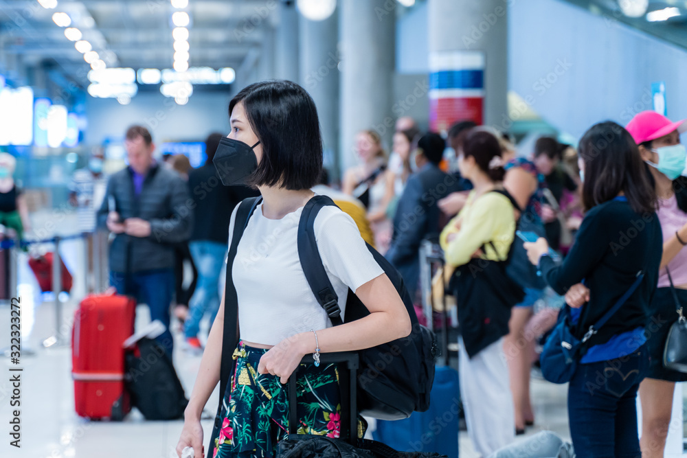 asian girl is wearing mask at the airport