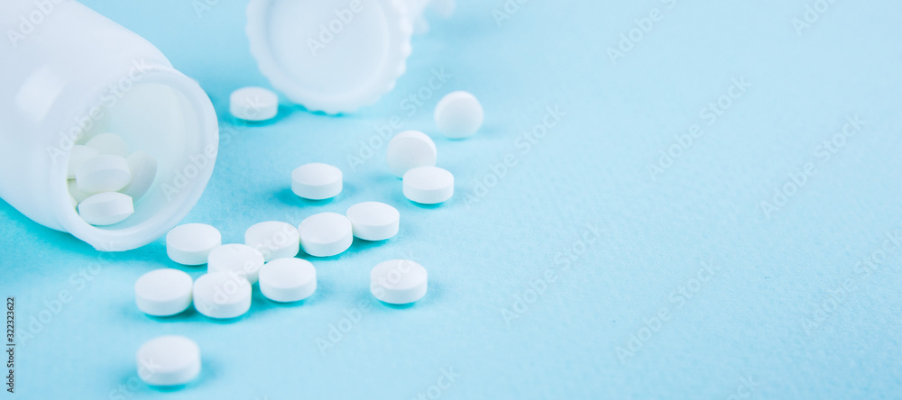 White tablets on a blue-green background. Copy space for text or disign - obrazy, fototapety, plakaty 