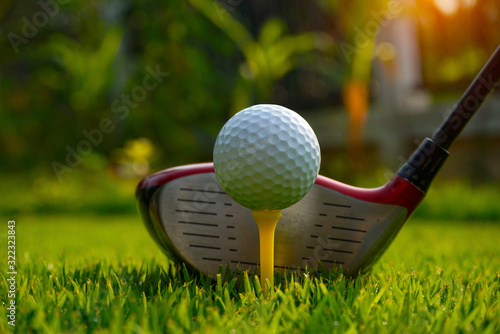 Golf ball and golf club in beautiful golf course at Thailand. Collection of golf equipment resting on green grass background