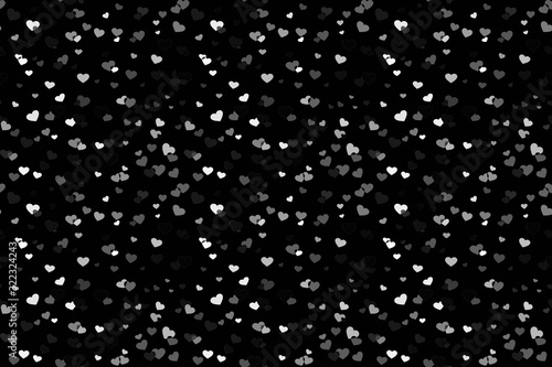 Abstract background picture with white hearts on a dark canvas. Festival of random falling and spinning confetti.