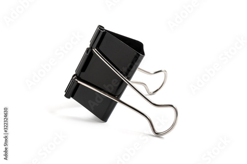 Black metal binder clip on white background isolated. Office paper clip tool for paper documents clamping. Stationery. Stainless steel foldback clips.