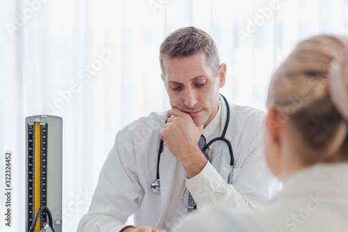 Doctor speaking to the patient in his office