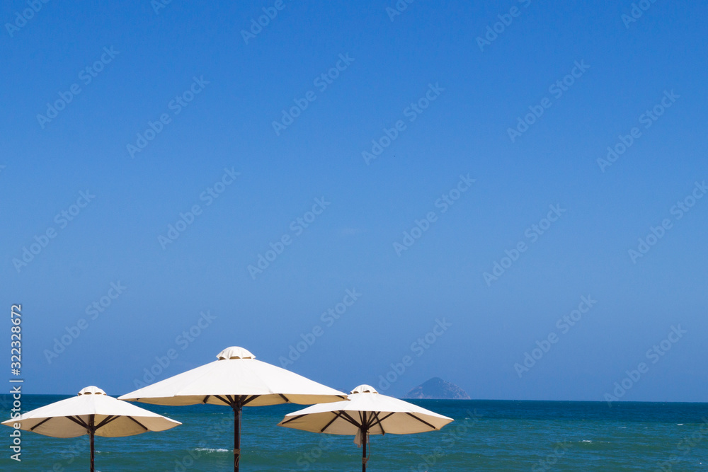 bright umbrellas on the beach by the sea