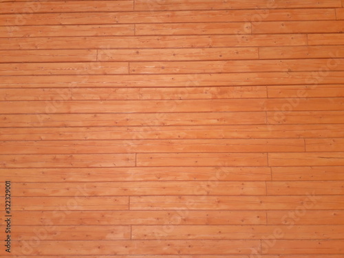 Wooden background. Texture of wood. The wall of a wooden house made of timber.